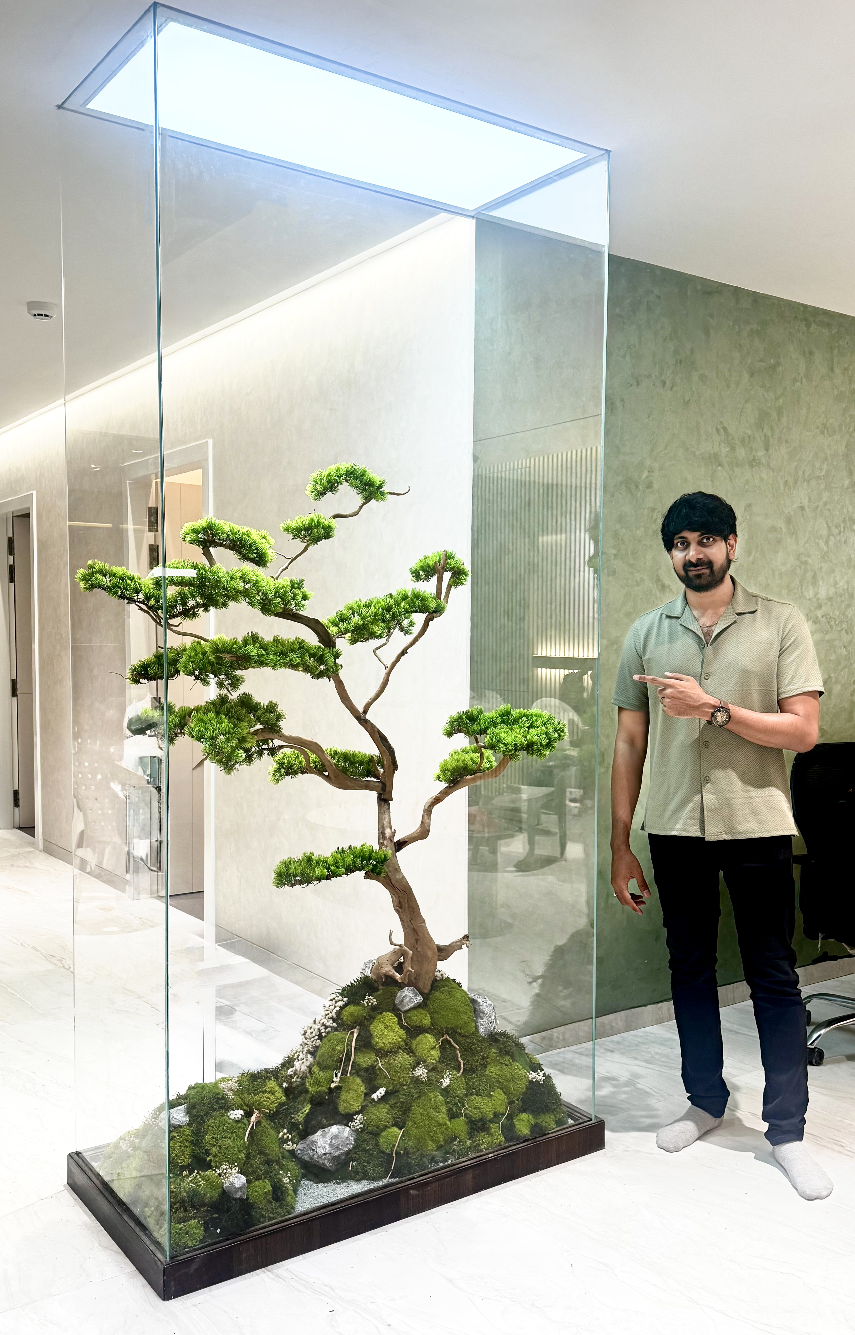 Sagar Varma standing beside a terrarium